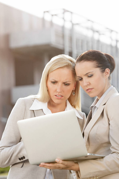 Serious businesswomen working on laptop  - Photo, image