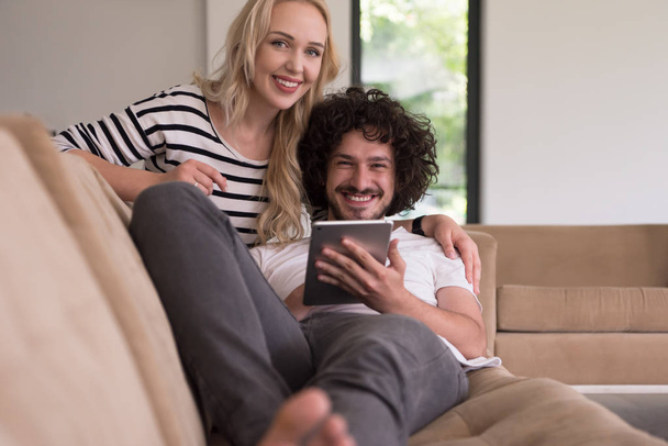 couple relaxing at  home with tablet computers - Фото, изображение
