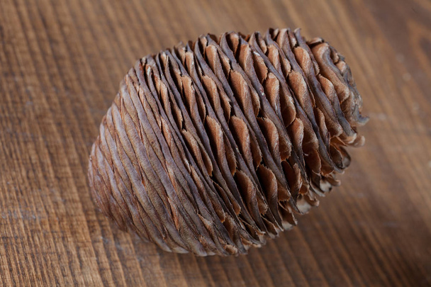 pinecone sawmills on the wooden table, note shallow depth of field - Photo, Image