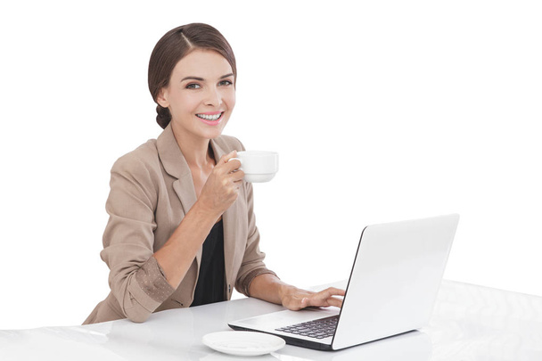 young businesswoman working while drinking a cup of tea - Fotoğraf, Görsel