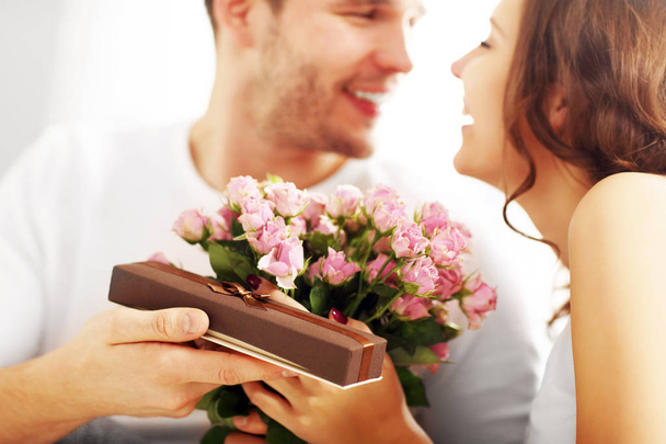 Homme donnant des fleurs et cadeau à la femme
  - Photo, image