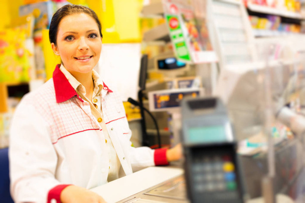 Sales Clerk At A Cash Register In The Supermarket - Фото, изображение
