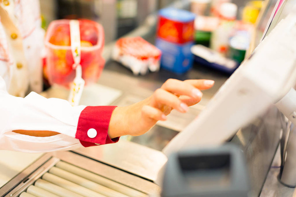 Sales Clerk At A Cash Register In The Supermarket - Фото, зображення