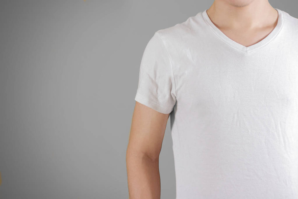 White t shirt on a young man template on gray. Isolated on grey  - Фото, зображення