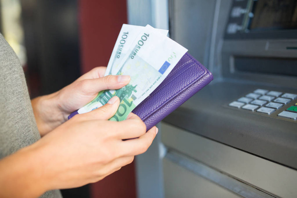 close up of hand withdrawing money at atm machine - Foto, Imagen