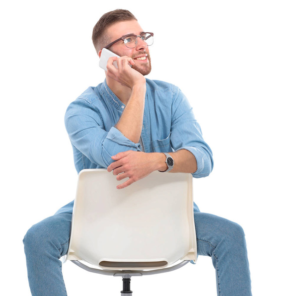 Young man sitting on the chair isolated over white background - Φωτογραφία, εικόνα