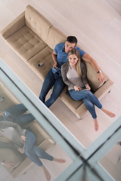 youg couple in living room with tablet top view - Photo, image