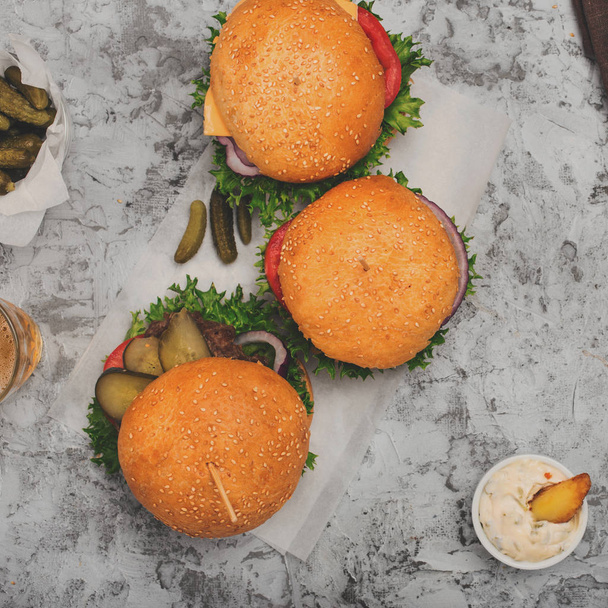 Three burger with fries on a white surface - Valokuva, kuva
