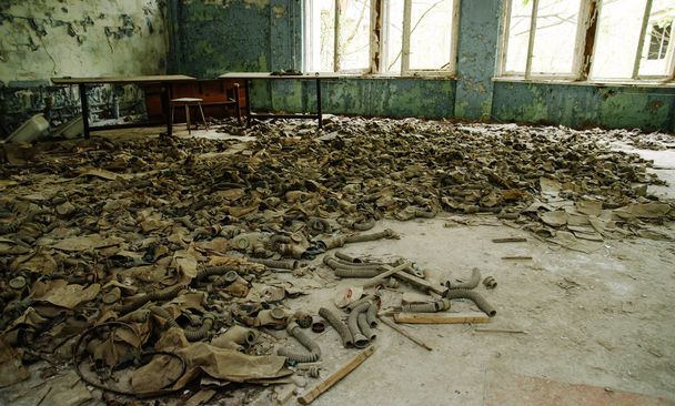 Infected radiation gas masks on the floor in an abandoned middle - 写真・画像