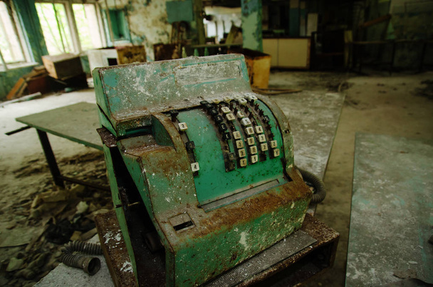Old rusty soviet calculating machine at Chernobyl city zone of r - Foto, Imagen
