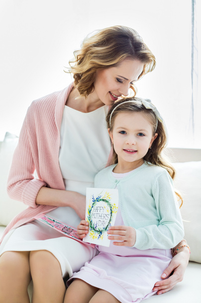 Beautiful mother and daughter with cards  - Photo, Image