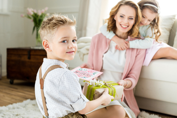 Boy presenting gift to mother - Photo, Image