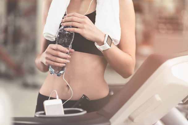 Slim woman holding a bottle after workout - Foto, Imagem