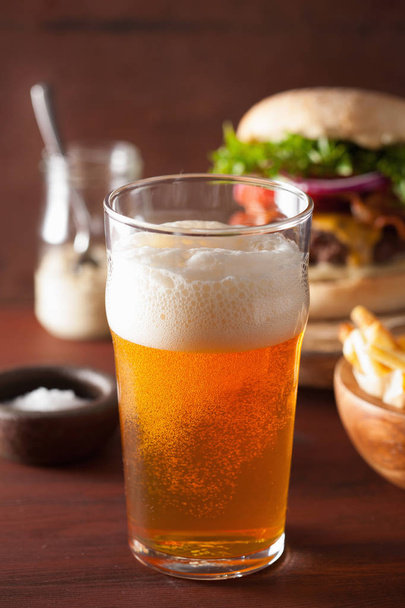 pint glass of india pale ale beer and fastfood - 写真・画像