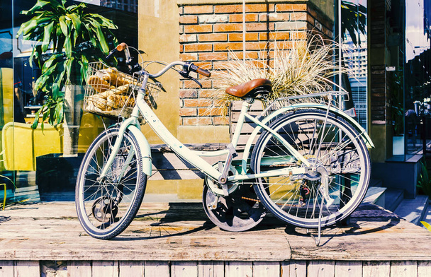 Vintage bicycle leaning against a wall  - Fotó, kép