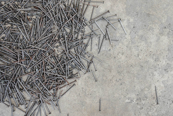 A lot of nail on the concrete floor - Fotó, kép
