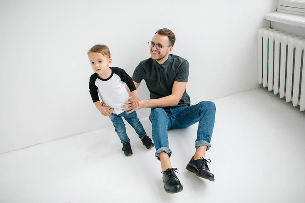 Young hipster father and baby boy on concrete floor - Foto, immagini