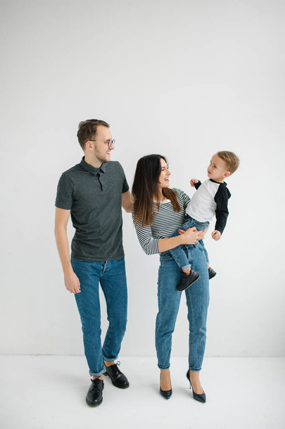 Hipster father, mother holding baby boy over white isolated background - Фото, зображення