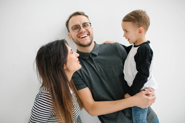 Hipster father, mother holding baby boy over white isolated background - Photo, Image