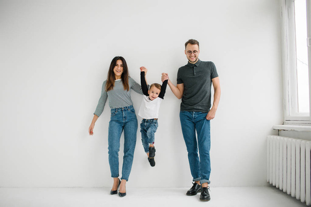 Hipster father, mother holding baby boy over white isolated background - Foto, Imagen