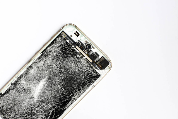 Broken mobile phone on white screen - Photo, Image