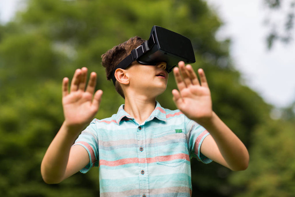 boy with virtual reality headset outdoors - 写真・画像