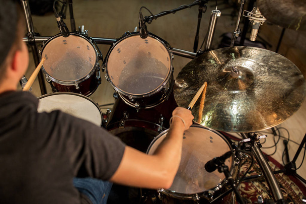 male musician playing drums and cymbals at concert - Foto, imagen
