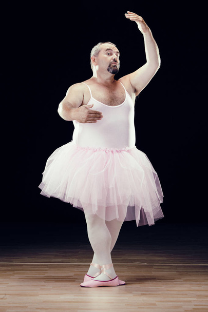 funny fat classical dancer on black background - Foto, Imagen