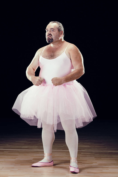 funny fat classical dancer on black background - Foto, Imagen