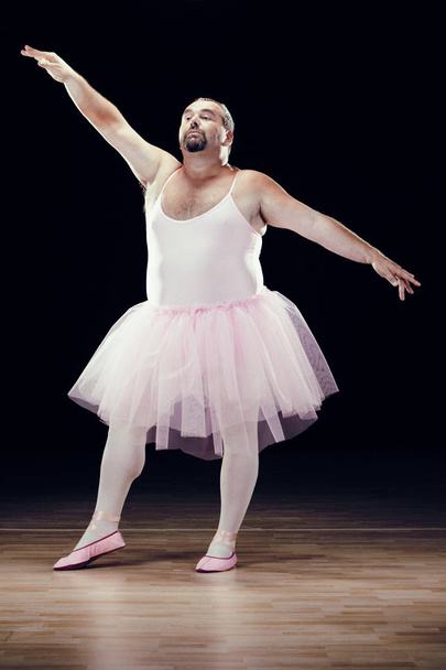 funny fat classical dancer on black background - Foto, Bild