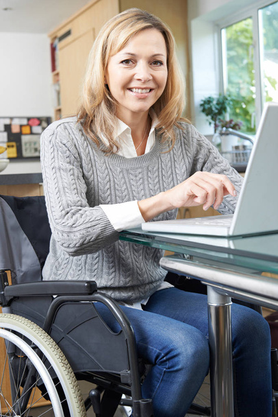 Disabled Woman In Wheelchair Using Laptop At Home - Foto, Bild