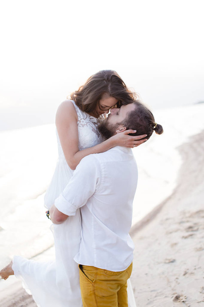 Beach honeymoon couple kissing and hugging on white sand beach - Foto, Bild