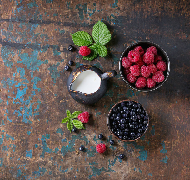 Bowls of raspberries and blueberries - Photo, Image