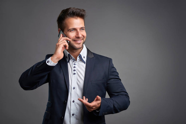 Elegant young man with a smartphone - Photo, image