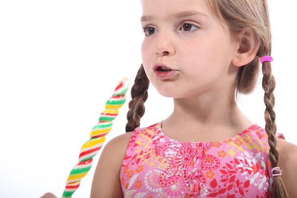Young girl eating candy - Valokuva, kuva