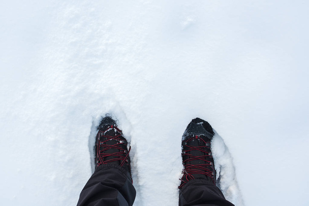 Man in winter boots standing in snow - Photo, image