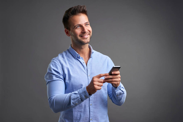 Young man with a smartphone	 - Фото, зображення