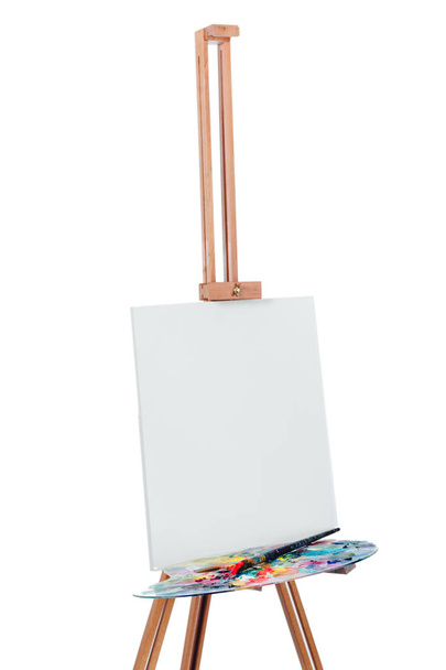 Tools of the artist. Brushes, wooden easel tripod, palette colorful. white background, studio, nobody. isolated - Fotografie, Obrázek