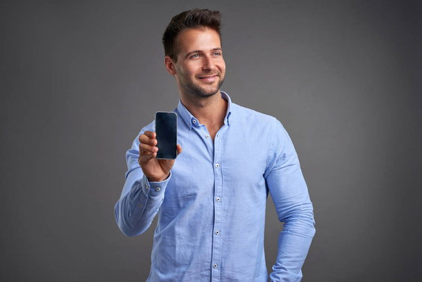 Young man with a smartphone - Fotoğraf, Görsel