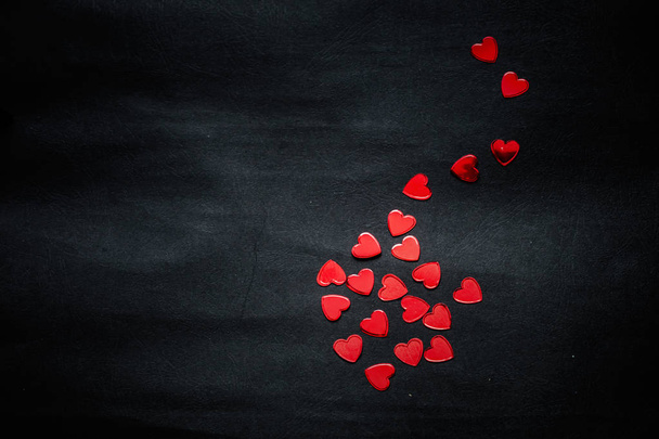 red hearts on black paper background  - Photo, Image