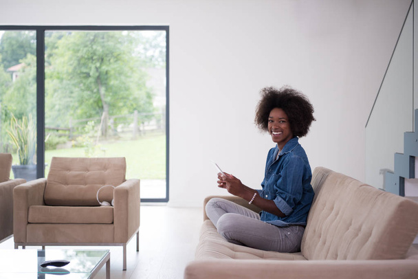 african american woman at home with digital tablet - Fotó, kép
