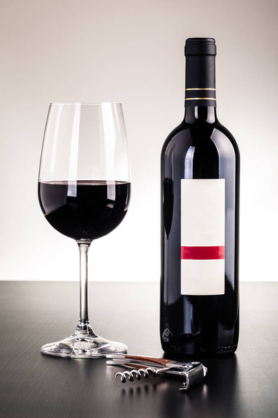 Red wine bottle and glass - Valokuva, kuva