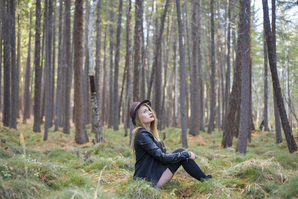 Beautiful young girl walking in the autumn forest. - 写真・画像