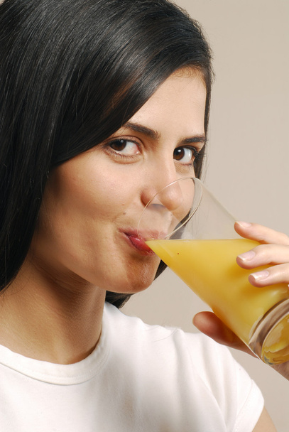 Young woman drinking orange juice - Фото, зображення