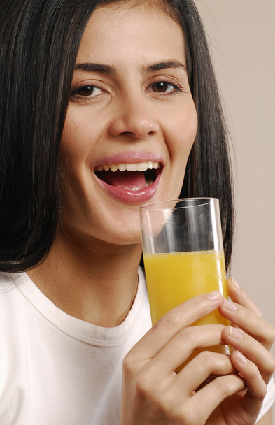 Young woman drinking orange juice - Foto, Imagen