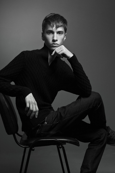 portrait of a handsome young man on a dark background - Fotó, kép