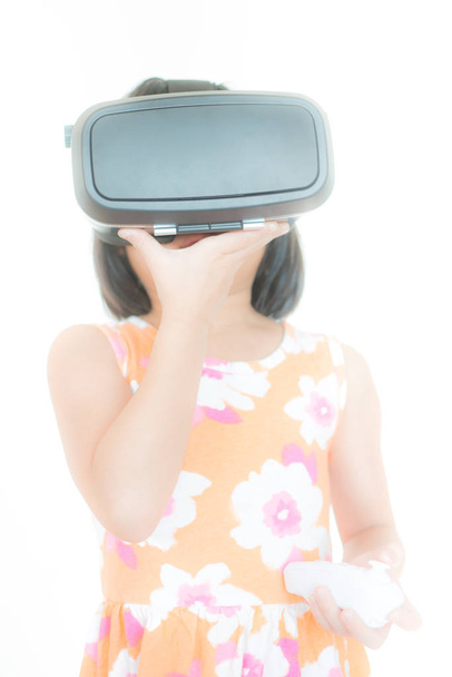 A girl using virtual reality for playing games. - Fotoğraf, Görsel