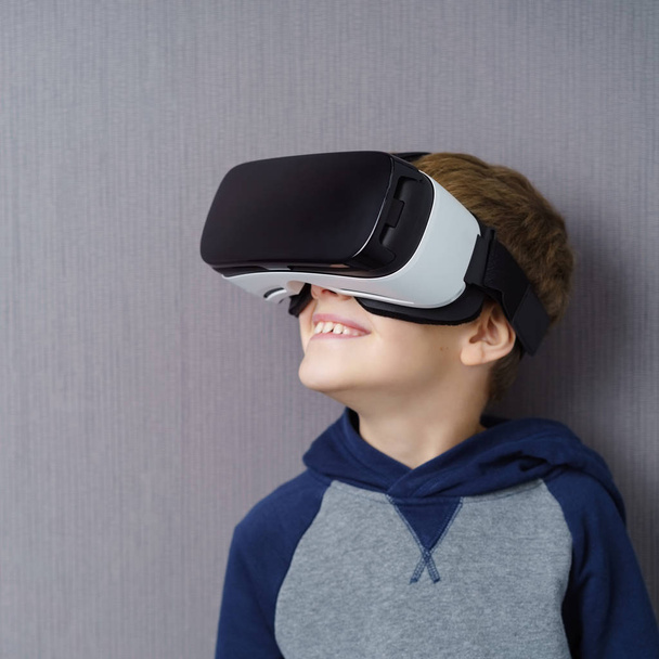 Young boy in VR headset - Фото, изображение