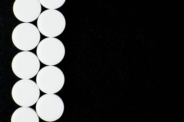 fehér tabletták a fekete háttér - Fotó, kép