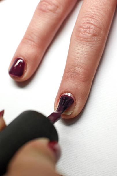 Manicure nail paint purple color. - Фото, изображение